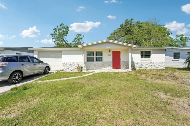 ranch-style home with a garage, a front lawn, and concrete driveway
