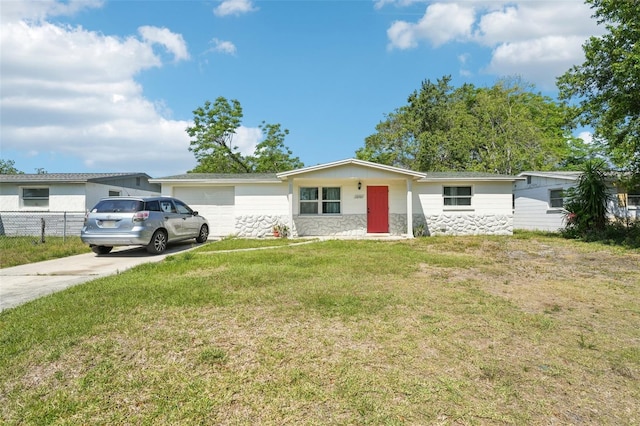 ranch-style home featuring fence, an attached garage, driveway, stone siding, and a front yard