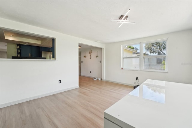 interior space with light wood-style floors and baseboards