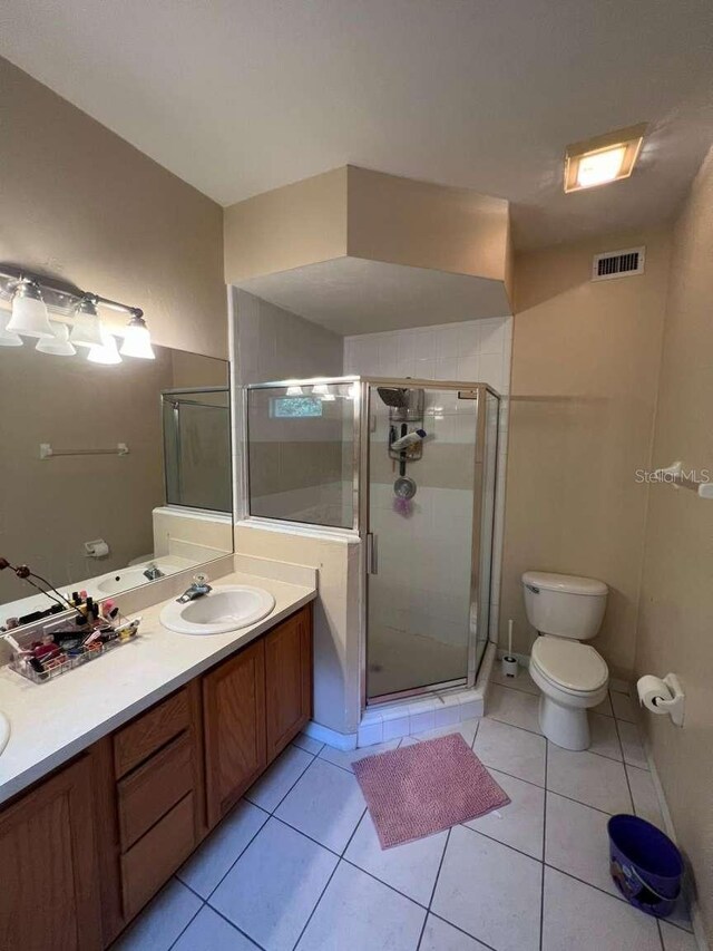 554 NW 50th Blvd, Gainesville, FL 32607 - full bath featuring visible vents, double vanity, toilet, a shower stall, and a sink