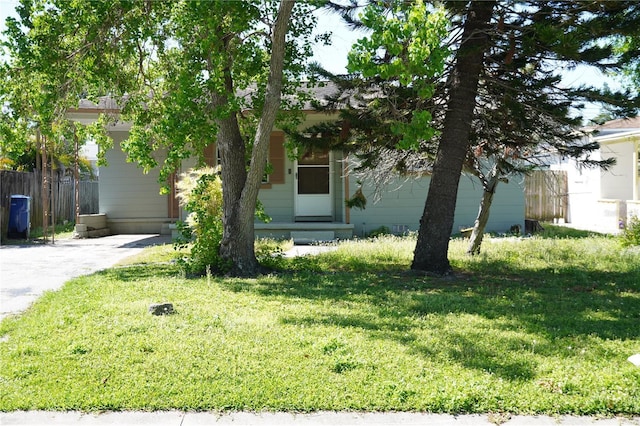 obstructed view of property with fence and a front yard