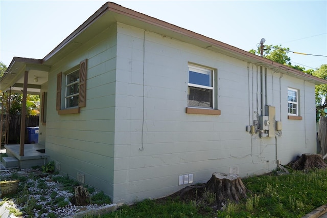 view of home's exterior featuring fence and concrete block siding