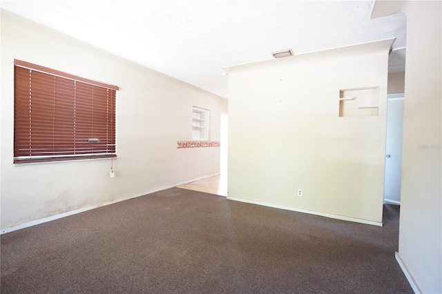empty room with visible vents and baseboards