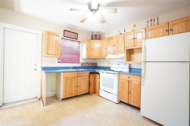 kitchen with light brown cabinetry, under cabinet range hood, a sink, and white appliances