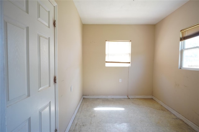 empty room featuring baseboards