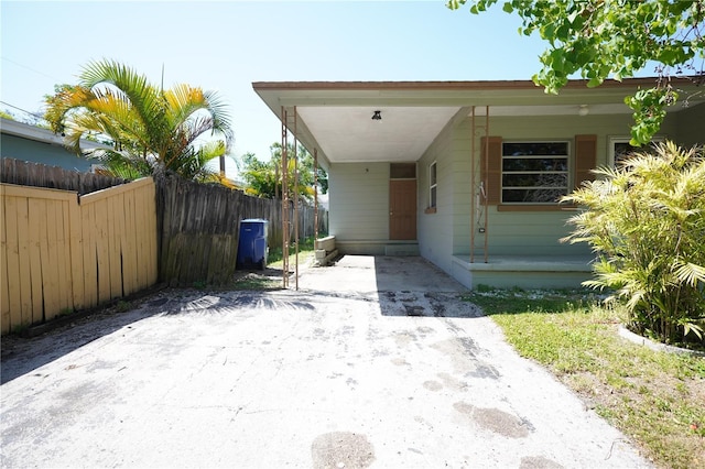 exterior space featuring fence and an attached carport