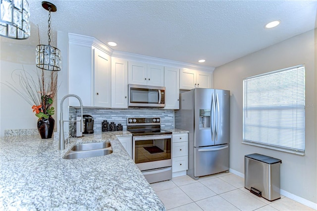 13870 Oakwood Ln Unit 13870, Seminole, FL 33776 - kitchen featuring white cabinets, appliances with stainless steel finishes, light tile patterned floors, and a sink