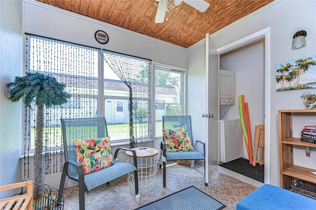13870 Oakwood Ln Unit 13870, Seminole, FL 33776 - living area featuring ceiling fan, wooden ceiling, stacked washer and clothes dryer, and plenty of natural light