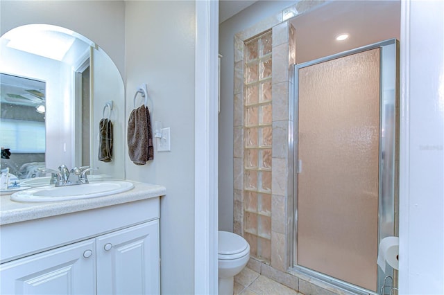 13870 Oakwood Ln Unit 13870, Seminole, FL 33776 - full bath featuring a shower stall, toilet, vanity, and tile patterned floors