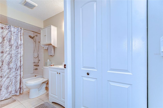 13870 Oakwood Ln Unit 13870, Seminole, FL 33776 - bathroom with tile patterned floors, a textured ceiling, toilet, shower / bathtub combination with curtain, and vanity