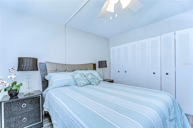 13870 Oakwood Ln Unit 13870, Seminole, FL 33776 - bedroom featuring a closet, wood finished floors, a textured ceiling, and ceiling fan