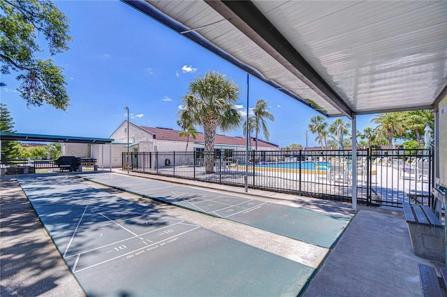 13870 Oakwood Ln Unit 13870, Seminole, FL 33776 - view of community featuring shuffleboard, uncovered parking, and fence