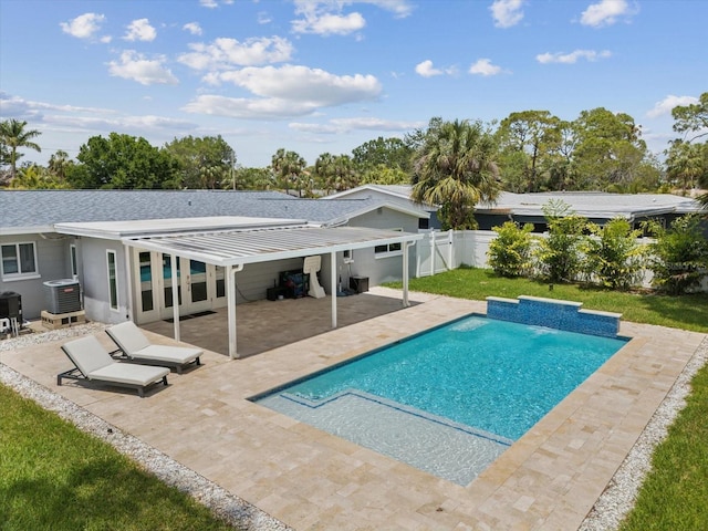 pool with cooling unit, a patio area, and a fenced backyard