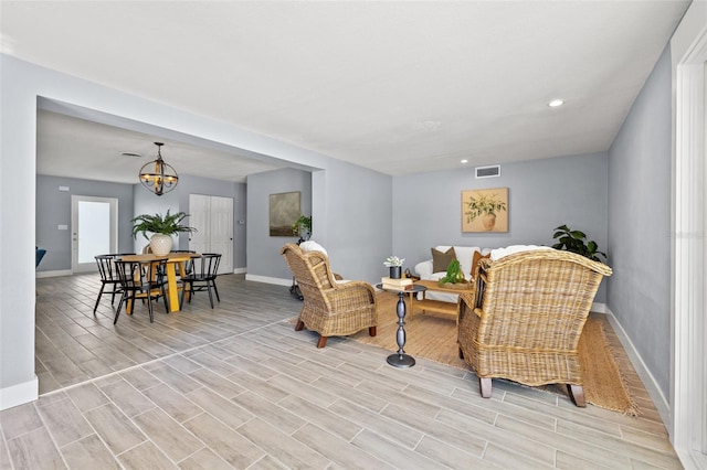 living area featuring recessed lighting, wood finish floors, visible vents, and baseboards