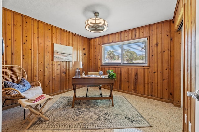 office space with wood walls and baseboards