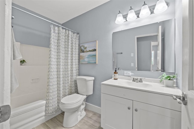 bathroom featuring wood finished floors, vanity, baseboards, shower / tub combo, and toilet