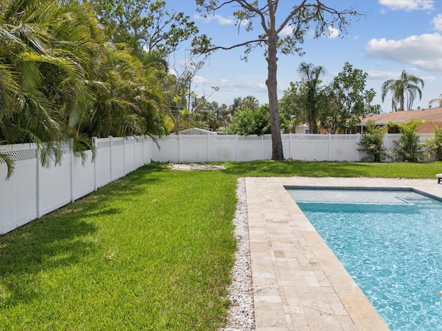 view of pool with a yard, a fenced in pool, and a fenced backyard