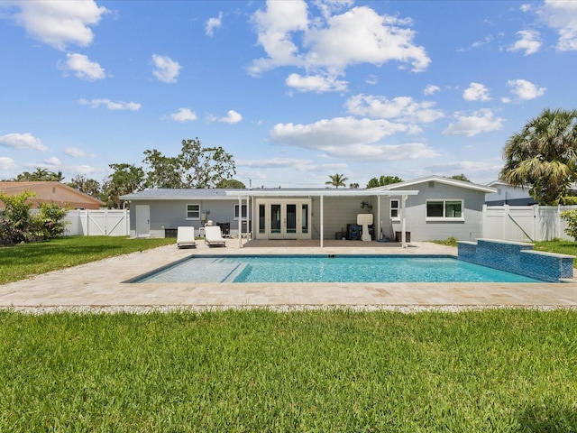 rear view of house featuring french doors, a fenced in pool, a fenced backyard, a gate, and a yard