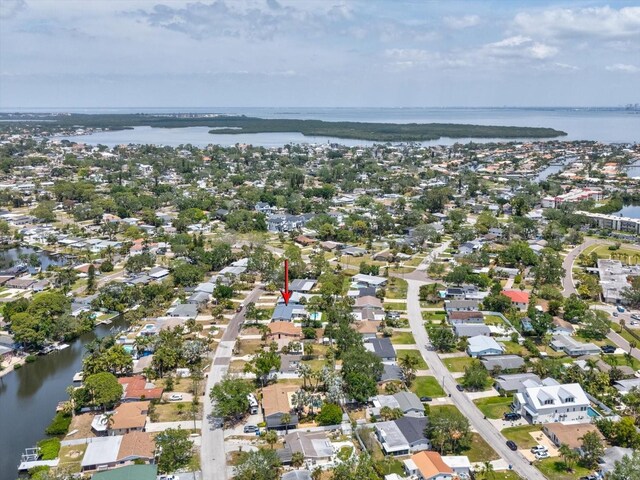 birds eye view of property with a water view and a residential view