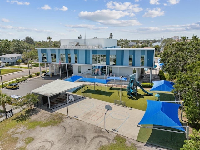 rear view of house featuring a playground