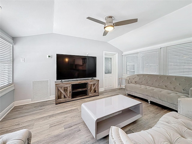 6609 Dartmouth Ave N, Saint Petersburg, FL 33710 - living room featuring vaulted ceiling, baseboards, visible vents, wood finished floors, and ceiling fan