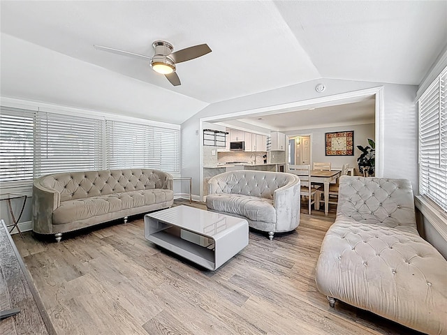 6609 Dartmouth Ave N, Saint Petersburg, FL 33710 - living area with baseboards, lofted ceiling, a ceiling fan, and light wood-type flooring