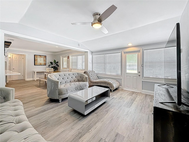 6609 Dartmouth Ave N, Saint Petersburg, FL 33710 - living room featuring light wood-type flooring, vaulted ceiling, baseboards, and a wealth of natural light