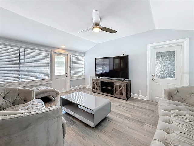 6609 Dartmouth Ave N, Saint Petersburg, FL 33710 - living room featuring lofted ceiling, a ceiling fan, baseboards, and light wood-type flooring