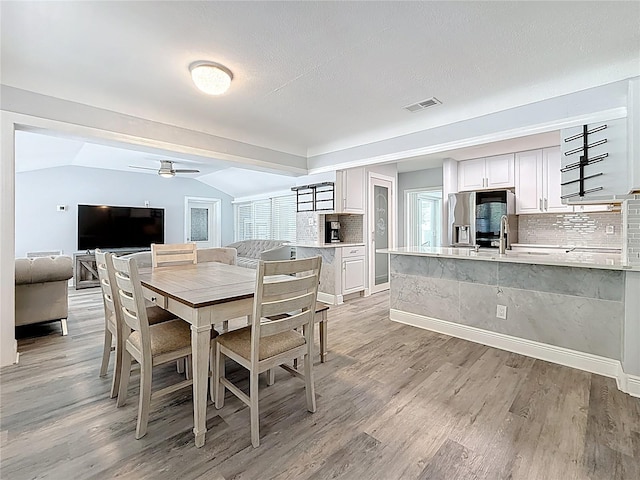 6609 Dartmouth Ave N, Saint Petersburg, FL 33710 - dining space with light wood-style flooring, visible vents, baseboards, and ceiling fan
