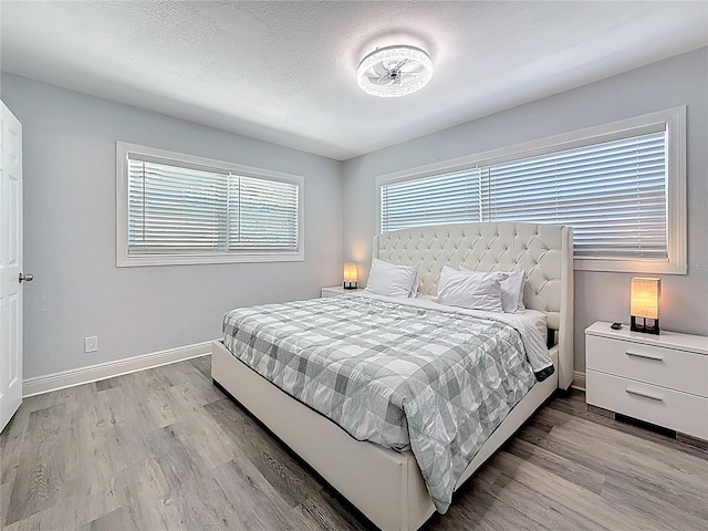 6609 Dartmouth Ave N, Saint Petersburg, FL 33710 - bedroom featuring baseboards and wood finished floors