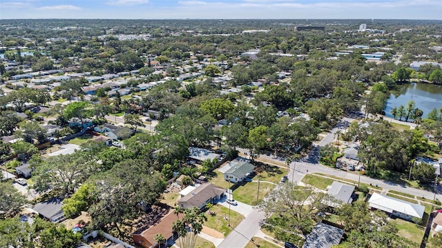 aerial view of property and surrounding area featuring a nearby body of water and nearby suburban area