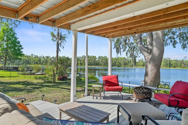 19254 Blount Rd, Lutz, FL 33558 - wooden deck with an outdoor fire pit, a water view, and view of scattered trees