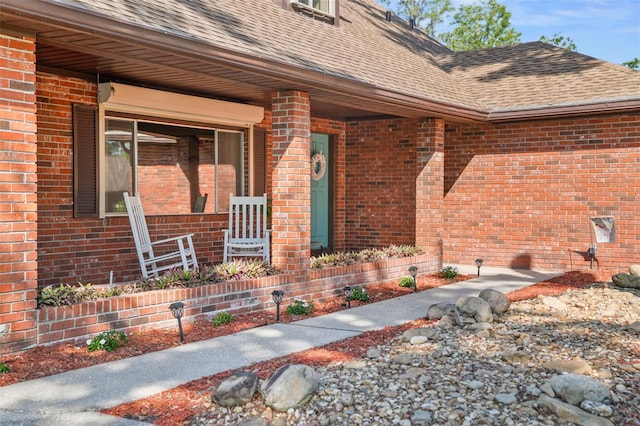 19254 Blount Rd, Lutz, FL 33558 - entrance to property with a shingled roof, brick siding, and covered porch