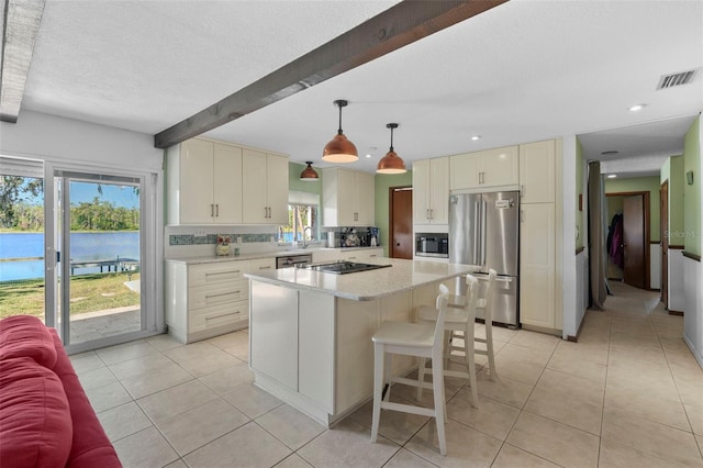 19254 Blount Rd, Lutz, FL 33558 - kitchen with appliances with stainless steel finishes, a sink, light tile patterned floors, a kitchen breakfast bar, and a kitchen island