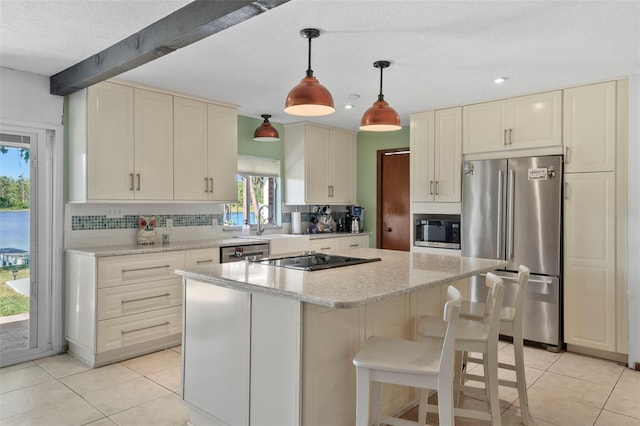 19254 Blount Rd, Lutz, FL 33558 - kitchen with stainless steel appliances, decorative backsplash, light tile patterned floors, a center island, and hanging light fixtures