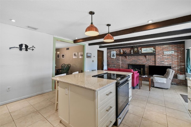 19254 Blount Rd, Lutz, FL 33558 - kitchen featuring electric range, light tile patterned flooring, brick wall, white cabinetry, and beam ceiling