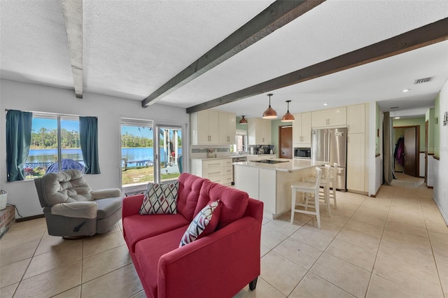 19254 Blount Rd, Lutz, FL 33558 - living area with beam ceiling, light tile patterned flooring, a textured ceiling, a water view, and recessed lighting