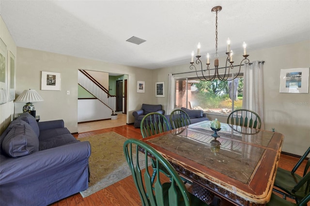 19254 Blount Rd, Lutz, FL 33558 - dining space featuring stairway, a chandelier, and wood finished floors