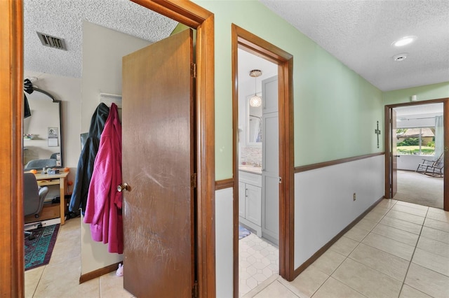 19254 Blount Rd, Lutz, FL 33558 - corridor with a textured ceiling and light tile patterned flooring