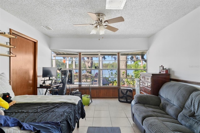19254 Blount Rd, Lutz, FL 33558 - bedroom featuring multiple windows, a desk, light tile patterned floors, a ceiling fan, and a textured ceiling