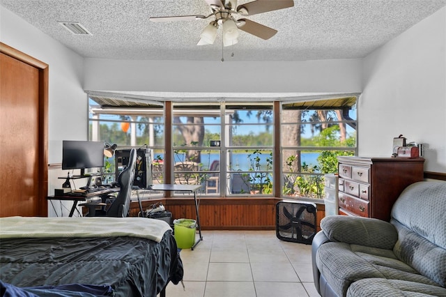 19254 Blount Rd, Lutz, FL 33558 - bedroom with light tile patterned flooring, a desk, a textured ceiling, and a ceiling fan