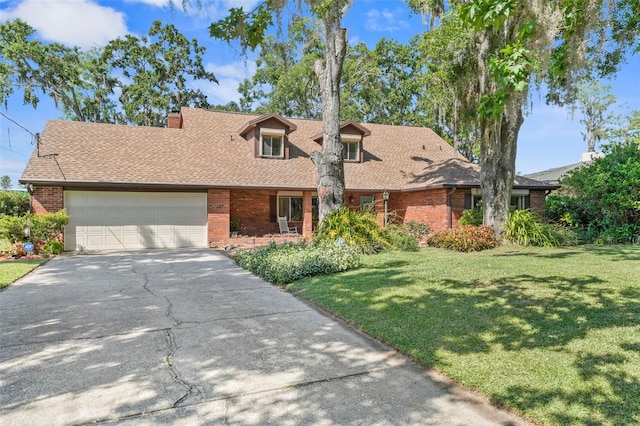 19254 Blount Rd, Lutz, FL 33558 - cape cod-style house with brick siding, asphalt driveway, a front yard, an attached garage, and a shingled roof