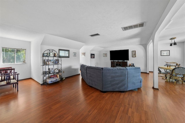 19254 Blount Rd, Lutz, FL 33558 - living area featuring wood finished floors, arched walkways, and a textured ceiling