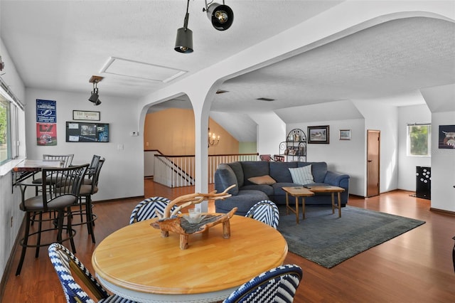 19254 Blount Rd, Lutz, FL 33558 - dining room featuring arched walkways, wood finished floors, and a textured ceiling