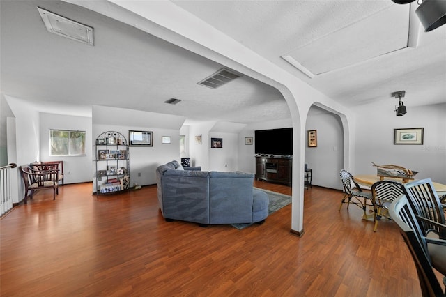 19254 Blount Rd, Lutz, FL 33558 - living room with wood finished floors, arched walkways, and a textured ceiling