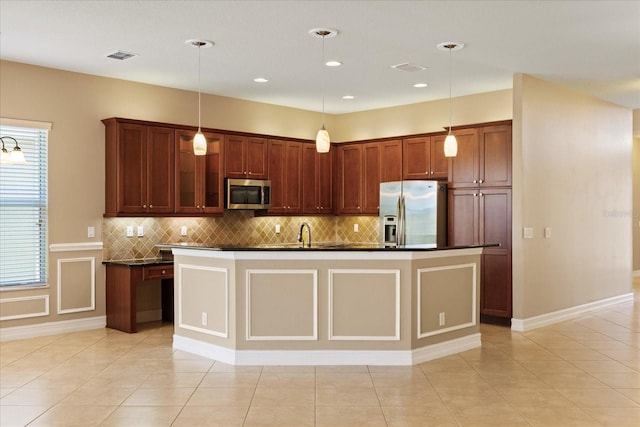 16055 Golden Lakes Dr, Wimauma, FL 33598 - kitchen featuring dark countertops, tasteful backsplash, stainless steel appliances, and light tile patterned flooring