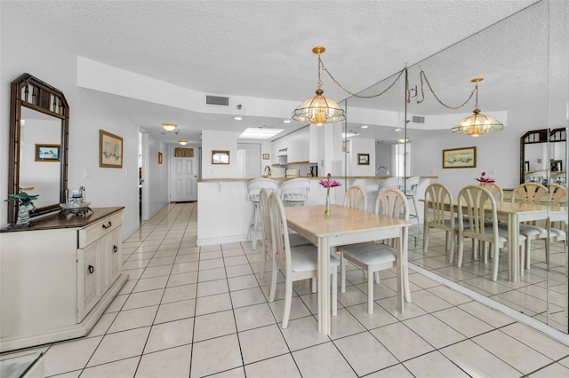 19925 Gulf Blvd Unit 503, Indian Shores, FL 33785 - dining room with light tile patterned floors, a textured ceiling, and a notable chandelier