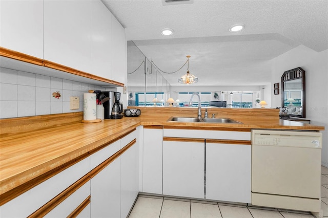 19925 Gulf Blvd Unit 503, Indian Shores, FL 33785 - kitchen with dishwasher, butcher block countertops, white cabinets, a sink, and backsplash