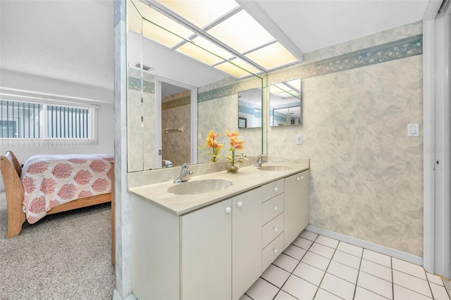 19925 Gulf Blvd Unit 503, Indian Shores, FL 33785 - ensuite bathroom with baseboards, a sink, ensuite bath, and double vanity