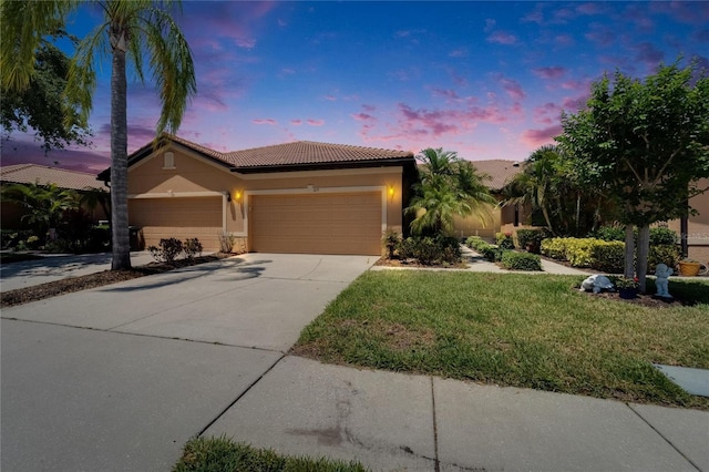 329 Seneca Falls Dr, Apollo Beach, FL 33572 - ranch-style home with an attached garage, stucco siding, a lawn, a tiled roof, and driveway